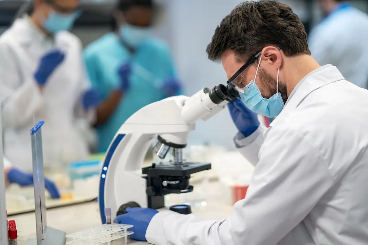 Laboratory researcher working with microscope